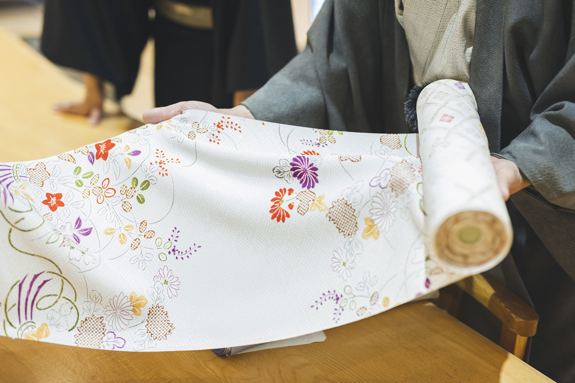 Unrolling kimono fabric reveals its elegant design